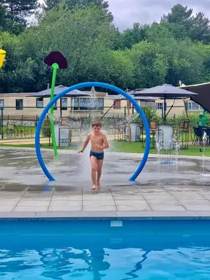 a young child is walking under a jump in a pool at Vakantiepark Breebos in Rijkevorsel