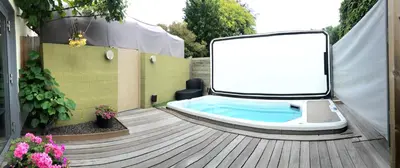 a bath tub sitting on a deck with a sign at B&B Oase in Londerzeel