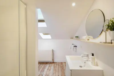 a bathroom with a sink and a mirror at Our Bird's Nest in the Heart of Antwerp in Antwerp