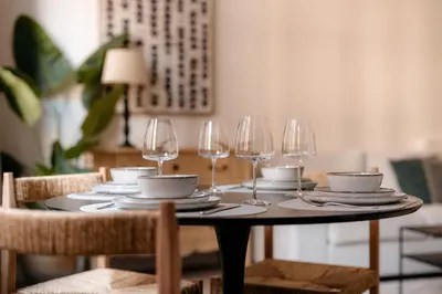 a table with wine glasses and plates on it at Cathedral view apartment in Antwerp
