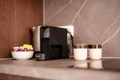 a kitchen counter with a microwave and two cups at Cathedral view apartment in Antwerp