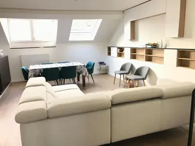 a living room with a couch and chairs and a table at Duplex avec terrasse quartier européen in Brussels