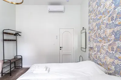 a bedroom with a bed and a floral wall at Room6 Van Lerius in Antwerp