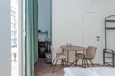 a dining room with a table and two chairs at Room6 Van Lerius in Antwerp