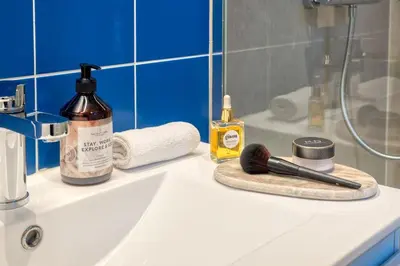 a bathroom counter with a sink with a brush on it at 2-BR Haven in Antwerp in Antwerp
