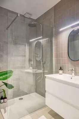 a bathroom with a shower and a tub and a sink at Cozy Retreat in Antwerp with balcony in Antwerp