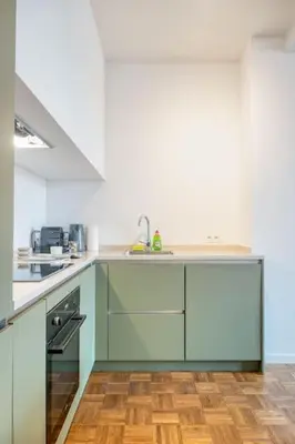 a kitchen with a sink and a stove at Magical renovated home in Antwerp in Antwerp