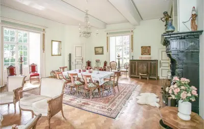 a dining room with a table and chairs at Kasteel Ter Leyen in Assenede