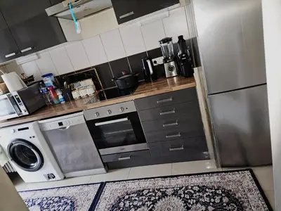 a kitchen with a washer and a stove and a refrigerator at Luxurious 3 in Brussels