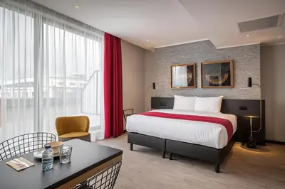 a hotel room with a bed and a table at Hotel Jamingo in Antwerp