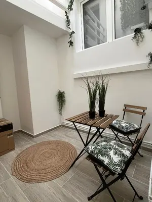 a living room with a table and two chairs at Rue blaes Appartement in Brussels