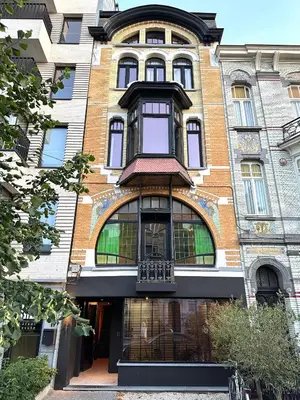 a large brick building with a balcony on it at Penthouse with Airconditioning and Big Terrace, Close to Gent Sint-Pieters Station and City Centre in Ghent