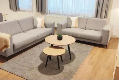 a living room with a couch and a table at Cosy 2 Bedroom Apartment in City Center in Brussels