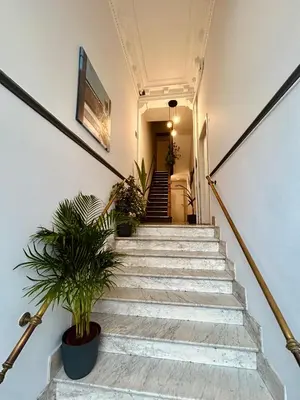 a staircase in a building with potted plants at European District Apartment Eleven in Brussels