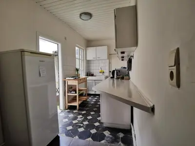 a kitchen with a sink and a refrigerator at Cozy city centre room with parkview in Ghent