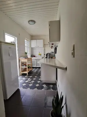 a kitchen with a refrigerator and a counter in it at Cozy city centre room with parkview in Ghent