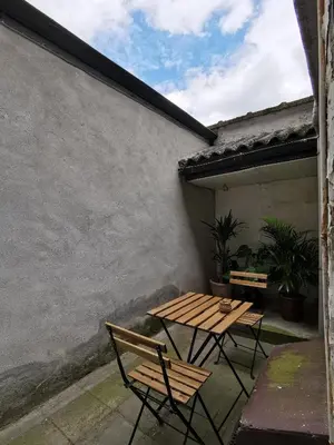 a picnic table and two chairs on a patio at Cozy city centre room with parkview in Ghent