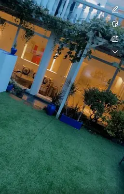 a large building with plants in a yard at majorelle in Brussels