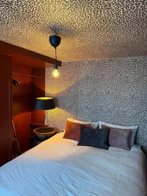 a bedroom with a white bed and a ceiling at RR Suite in Antwerp