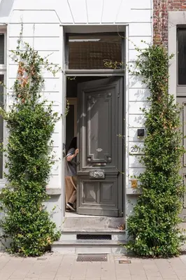 a man standing in the door of a house at Historic Ghent Building - Ideal Studio Retreat in Ghent
