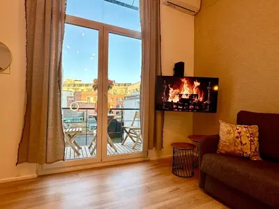 a living room with a large window with a view at Luxury Suits Royal by Rikas Hotels in Antwerp