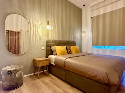 a bedroom with a large bed and a mirror at Luxury Suits Royal by Rikas Hotels in Antwerp