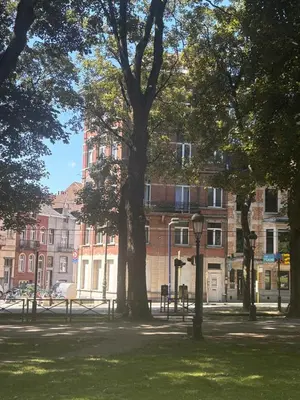 a park with trees in front of a building at Studio Nour in Brussels