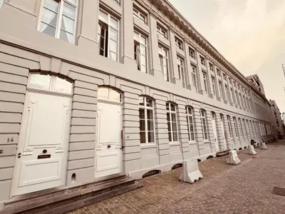 a row of white doors on a building at Studio Tintin in Brussels