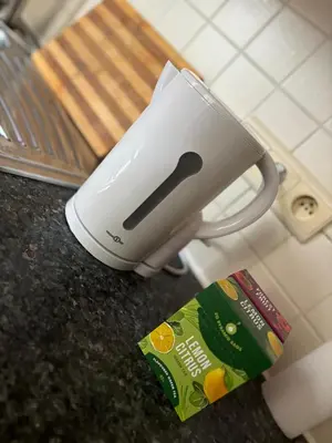 a toaster sitting on top of a counter next to a book at L&L Residence in Brussels