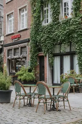 a table and chairs in front of a building at SHWAY - The Proof Reader in Antwerp