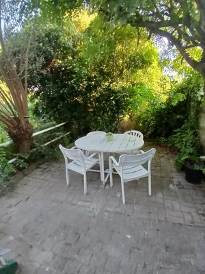 a white table and two chairs on a patio at Assenaar in Asse