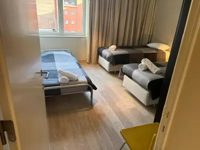 a small room with two beds and a window at Luxurious Two Bedroom Apartment in Brussels