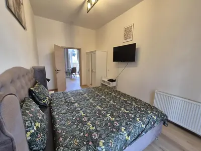 a bedroom with a bed and a flat screen tv at Modern apartment near Avenue Louise in Brussels