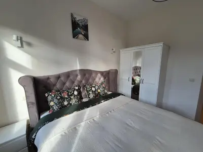 a bedroom with a large bed with a headboard at Modern apartment near Avenue Louise in Brussels