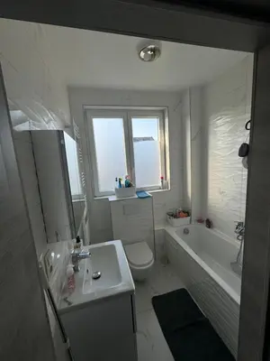 a bathroom with a tub and a toilet and a sink at Simpleroom in Brussels