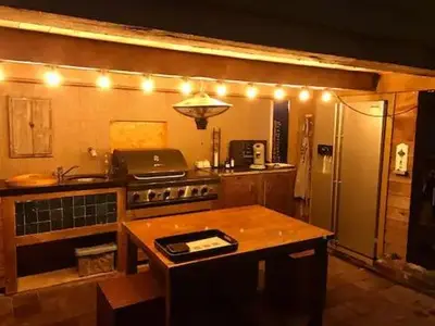 a kitchen with a stove and a refrigerator with lights at Peace in Assenede