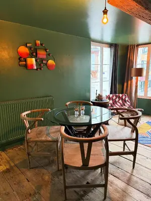 a living room with a glass table and chairs at Cosy Boudoir Suites - 4p in Antwerp