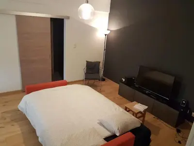 a bedroom with a bed and a flat screen tv at Fully equipped two bedroom apartment Schuman area in Brussels