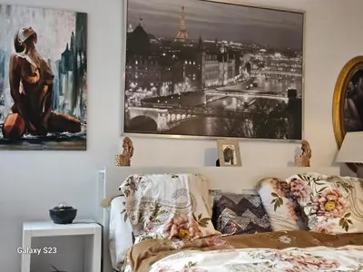 a bedroom with a bed and a picture on the wall at Friend House in Brussels