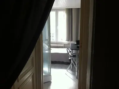 a room with a bed and a window with at Hotel Residence 18 in Brussels