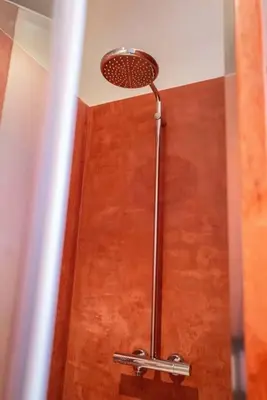 a shower with a shower head in a bathroom at Studio Retreat in the Centre of Ghent in Ghent