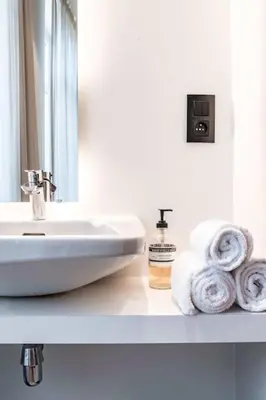 a bathroom with a sink and towels on a counter at Cozy Studio for Two in Central Ghent in Ghent