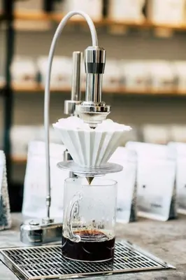 a coffee maker sitting on a table with a glass at Charming Studio Retreat for Two in Central Ghent in Ghent