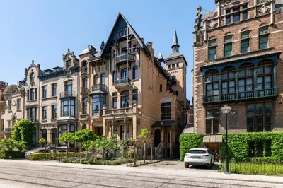 a building with a car parked in front of it at Boutique Baron Osy Suite Second Street in Antwerp