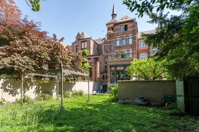 a yard in front of a brick building at Boutique Baron Osy Suite Second Street in Antwerp