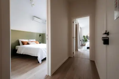 a bedroom with a bed and an open door at Cathedral View luxurious Apartment in Antwerp