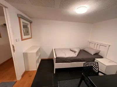 a small room with a bed and a desk at Bruxelles centre-ville in Brussels