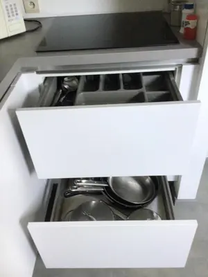 an open drawer in a kitchen with pots and pans at Cosy attic apartment, terrace, 1 bedroom, double bed for 2 plus single bed if 3 guests in Buggenhout
