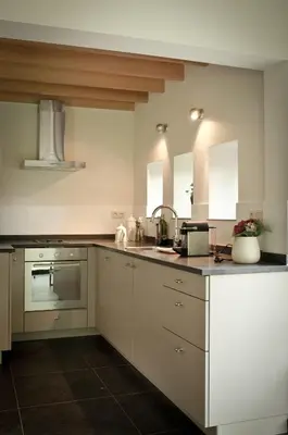 a kitchen with white cabinets and a sink at Geestmolenhof 1 in Holsbeek