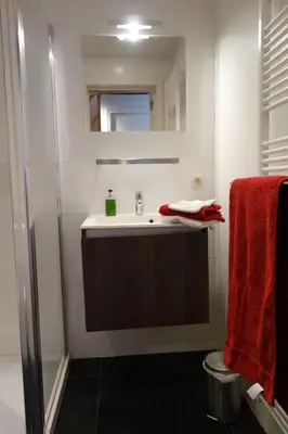 a bathroom with a sink and a shower at Geestmolenhof 2 in Holsbeek